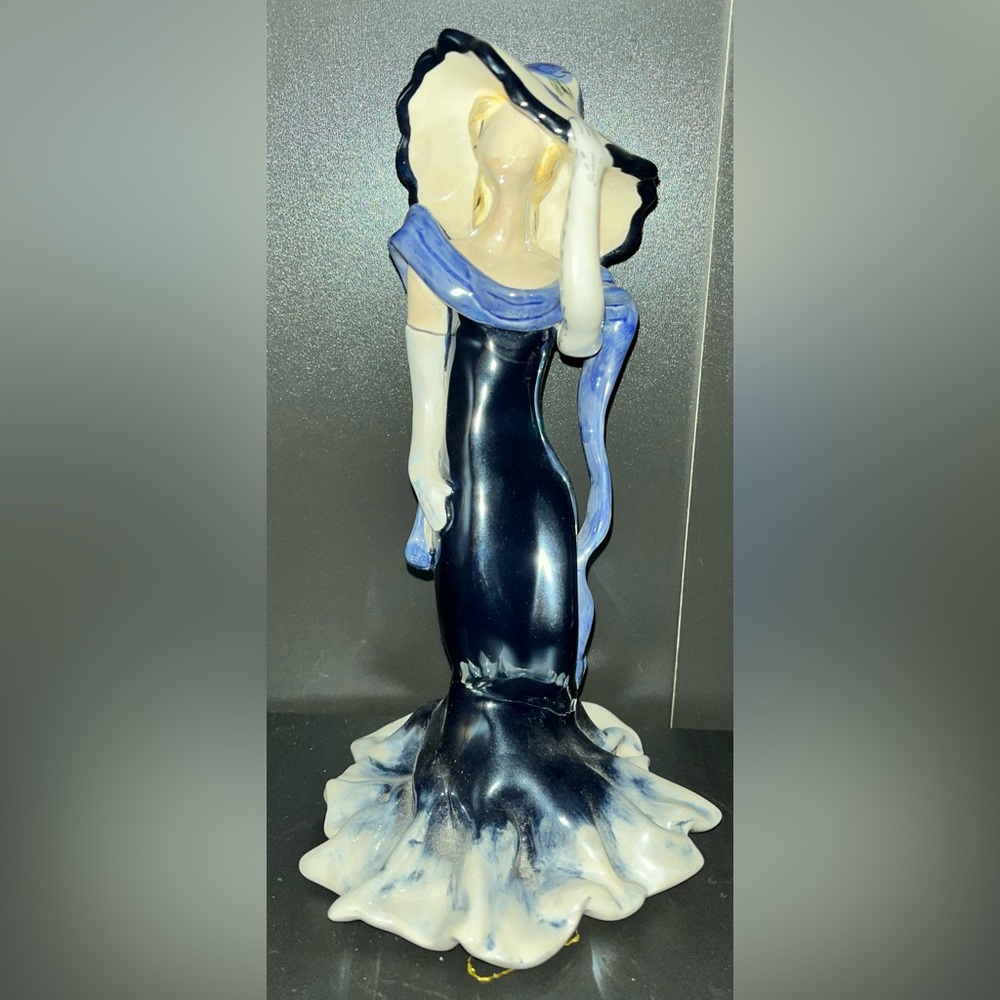 Heather Goldminc vintage woman wearing blue dress and blue flower hat figurine.